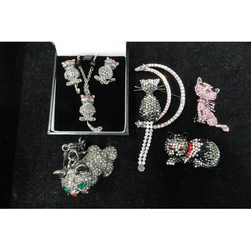 191 - A group of Butler and Wilson Designer cat themed jewellery comprising: cat on crescent moon brooch, ... 