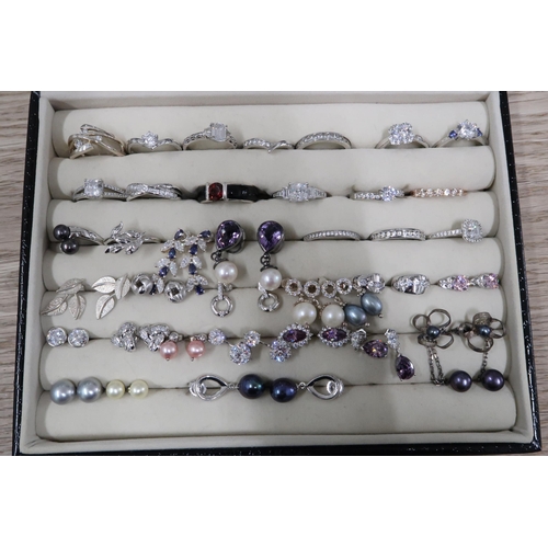 216 - A group of fifteen cubic zirconia set silver rings, another set with grey pearls, and two further si... 