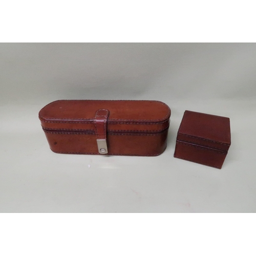 217 - A leather bound jewellery box of lozenge form with stitched leather and fitted interior 21 by 7 by 7... 