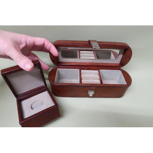 217 - A leather bound jewellery box of lozenge form with stitched leather and fitted interior 21 by 7 by 7... 