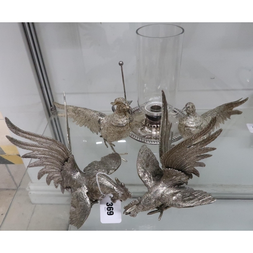 369 - A pair of silver plated fighting cocks, a pair of similar pheasants, and a silver plated chamber sti... 