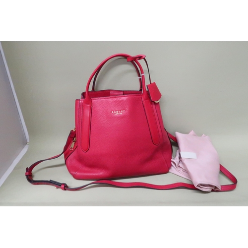 453 - A Radley red leather handbag, 34 by 16 by 34cm high including handles, complete with cloth cover bag... 