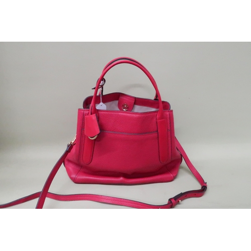 453 - A Radley red leather handbag, 34 by 16 by 34cm high including handles, complete with cloth cover bag... 