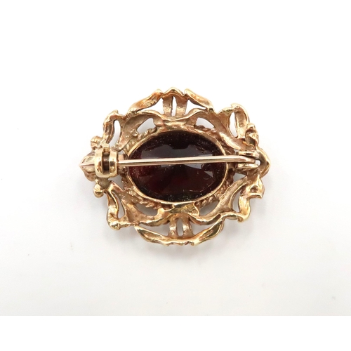 52 - A 9ct gold oval garnet brooch. Weight 5.78 grams
