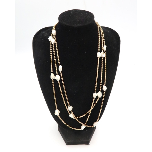 85 - A muff chain with freshwater culture pearl spacer links. Tests gold 9ct. Weight 20.98 grams Length a... 