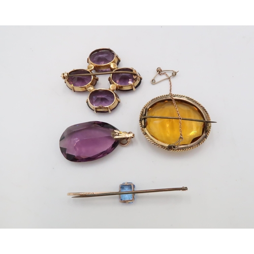 83 - A group of paste jewellery, to include three brooches and a pendant. Mounts test 9ct gold. Weight 50... 