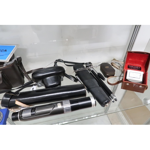 525 - An assortment of vintage cameras and camera accessories to include Chinon CM4, Konica EE Matic, Sang... 
