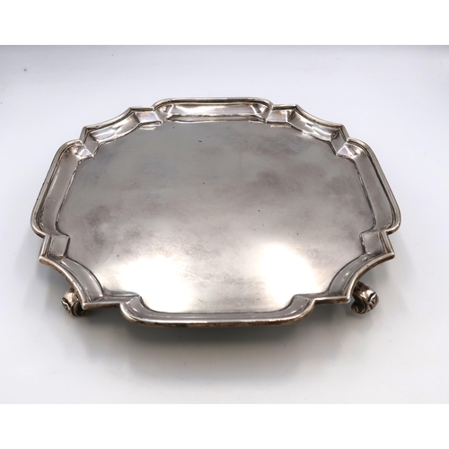 362 - A late Victorian silver salver, with pie-crust rim, raised on four scroll feet, Charles Stuart Harri... 