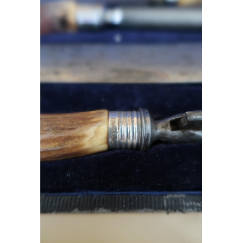 372 - A Mappin and Webb vintage steel carving set with silver collars and stag-horn handles, comprising st... 