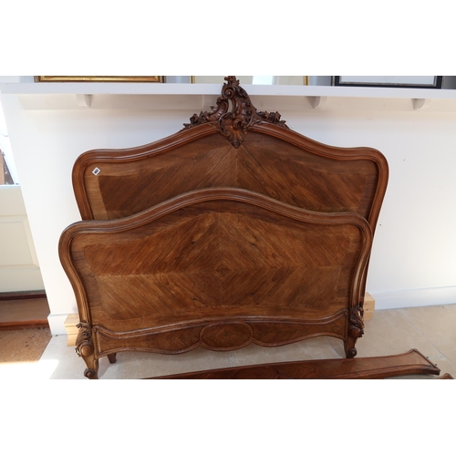 603 - A Continental walnut double bed approx 4ft 6 inches wide complete with the base slats