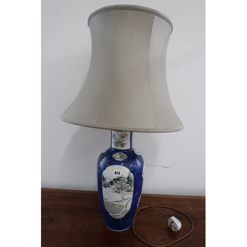 672 - A table lamp and shade - in working order - Height 81cm