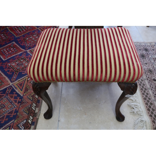 673 - A small footstool on cabriole legs