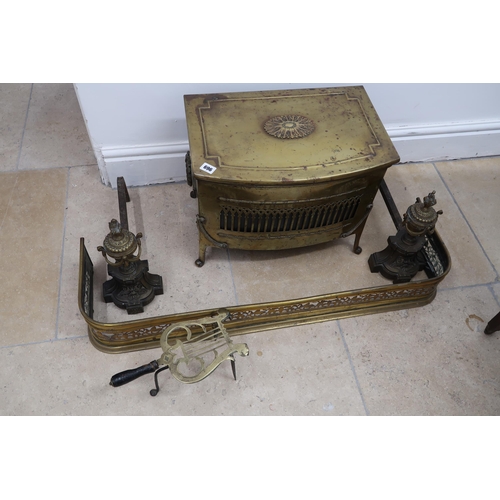 696 - A brass coal box, a pair of fire dogs, a trivet and brass fender - Width 93cm