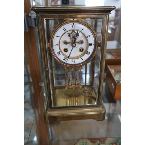 699 - A brass 8 day four glass clock with mercury pendulum