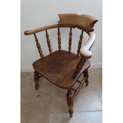 708 - A 19th century smokers bow armchair