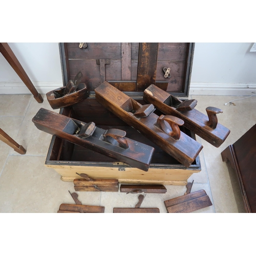 712 - A 19th century pine chest with a collection of early woodworking tools