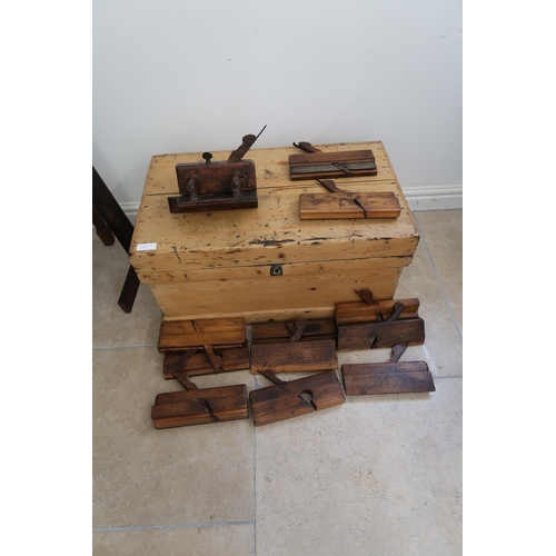 712 - A 19th century pine chest with a collection of early woodworking tools