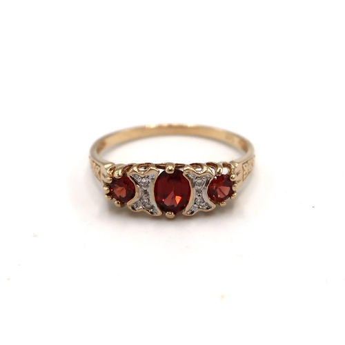 79 - A 9ct Yellow Gold 3 Stone Diamond and Garnet Ring, Head Size approx. 15mm x 6mm - Ring Size approx. ... 