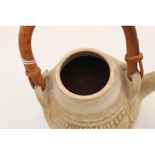 507 - A Japanese stoneware teapot, with inscribed leaf and tree decoration, with bent bamboo handle, singl... 
