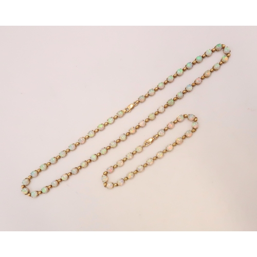 90 - An 18ct gold and Australian opal suite of jewellery comprising necklace and bracelet set with fourty... 