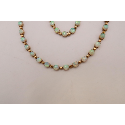 90 - An 18ct gold and Australian opal suite of jewellery comprising necklace and bracelet set with fourty... 
