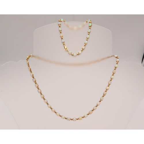 90 - An 18ct gold and Australian opal suite of jewellery comprising necklace and bracelet set with fourty... 