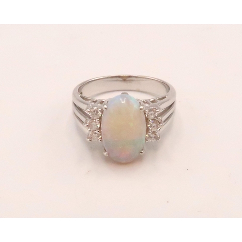 93 - An 18ct white gold, diamond and opal dress ring, the opal from Coober Pedy, Australia, with good mov... 