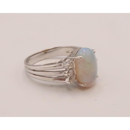 93 - An 18ct white gold, diamond and opal dress ring, the opal from Coober Pedy, Australia, with good mov... 