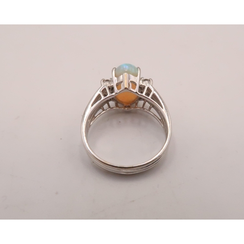 93 - An 18ct white gold, diamond and opal dress ring, the opal from Coober Pedy, Australia, with good mov... 