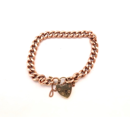 95 - A 9ct gold curb link charm bracelet with heart shaped padlock clasp, fully marked to back of clasp a... 