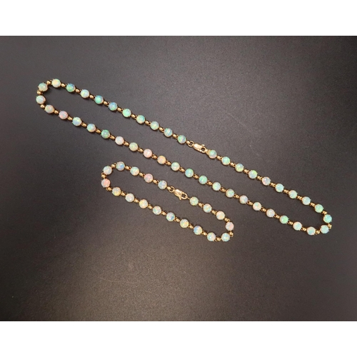90 - An 18ct gold and Australian opal suite of jewellery comprising necklace and bracelet set with fourty... 