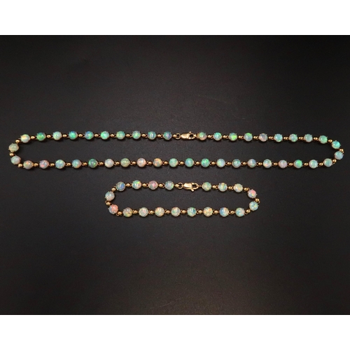 90 - An 18ct gold and Australian opal suite of jewellery comprising necklace and bracelet set with fourty... 