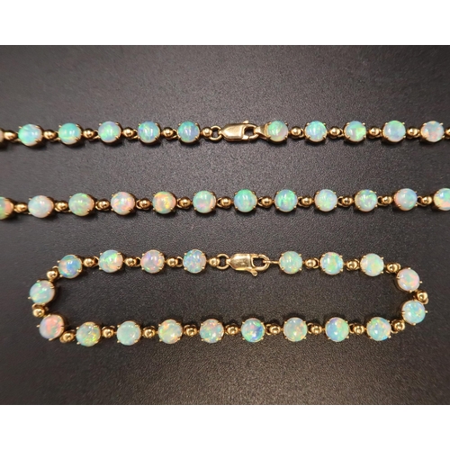 90 - An 18ct gold and Australian opal suite of jewellery comprising necklace and bracelet set with fourty... 