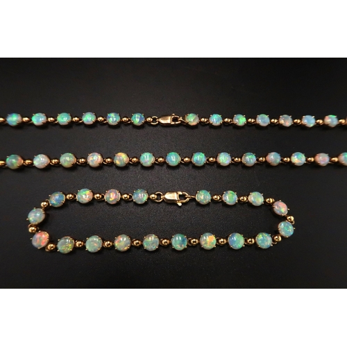 90 - An 18ct gold and Australian opal suite of jewellery comprising necklace and bracelet set with fourty... 