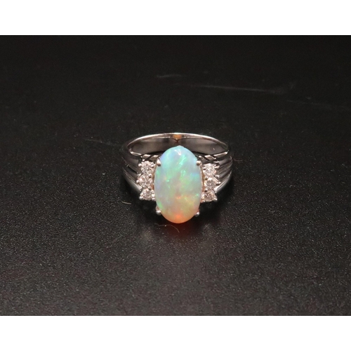 93 - An 18ct white gold, diamond and opal dress ring, the opal from Coober Pedy, Australia, with good mov... 