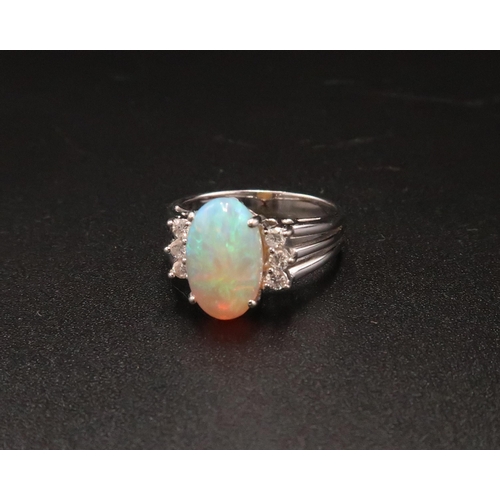 93 - An 18ct white gold, diamond and opal dress ring, the opal from Coober Pedy, Australia, with good mov... 