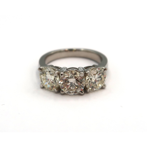 An Impressive Platinum 3 Stone Diamond Ring, Total Carat Weight approx. 3.39crts, Diamonds are Well Matched and a Good Clarity, Colour approx. I, Clarity approx. VSI, Comes with a Current GIE Certificate with a
Valuation of £18,500, Ring Size approx. L/M