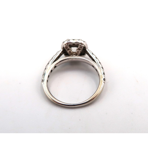 12 - A 14ct Diamond Halo Cluster style ring, with diamond set shoulders. 

Approximate total diamond weig... 