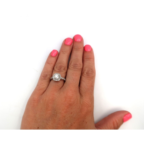 12 - A 14ct Diamond Halo Cluster style ring, with diamond set shoulders. 

Approximate total diamond weig... 