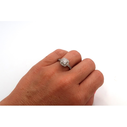 12 - A 14ct Diamond Halo Cluster style ring, with diamond set shoulders. 

Approximate total diamond weig... 