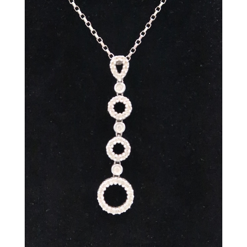 13 - A 9ct gold diamond openwork circle drop pendant. Estimated total weight 0.60ct. Weight 4.86 grams
