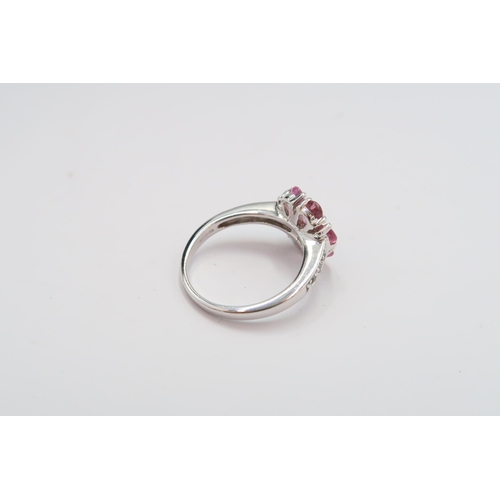 23 - A 9ct gold pink and white sapphire flower ring. Size N 1/2. Weight 3.96 grams