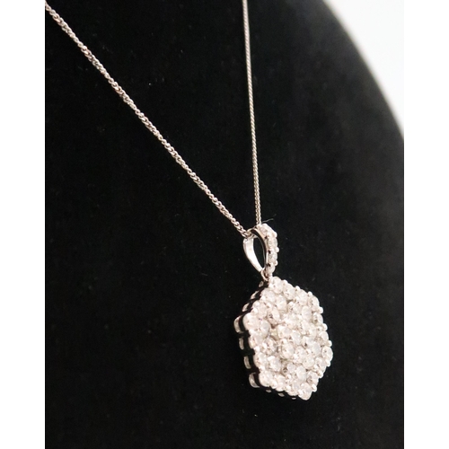 6 - An 18ct gold hexagonal diamond cluster pendant. Estimated total diamond weight 1.55ct. Estimated H/I... 