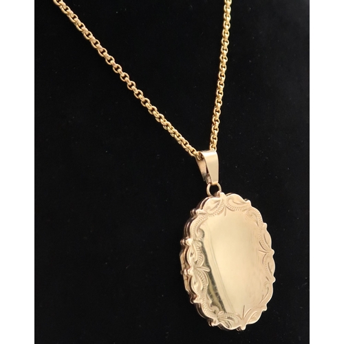 60 - A 9ct gold oval locket and chain. Weight 14.67 grams