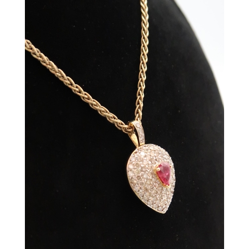 7 - A pear shape ruby and diamond cluster pendant. Estimated total diamond weight 1.50ct J-M SI1/2. Stam... 