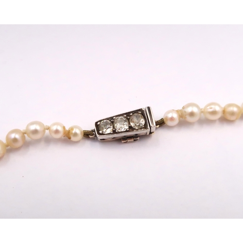 11 - A Freshwater pearl necklace with Platinum & 14ct Diamond set clasp. Approximately 0.60ct.

(Matches ... 