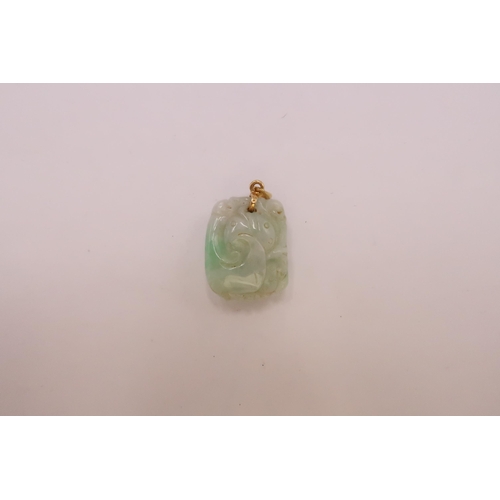 43 - A carved jade pendant. Length 20mm. Pendant fitting stamped 18K. Weight 8.71 grams