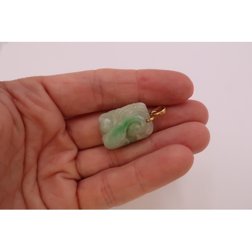 43 - A carved jade pendant. Length 20mm. Pendant fitting stamped 18K. Weight 8.71 grams