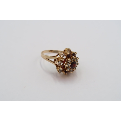 63 - A 9ct Garnet & White stone cluster ring. 

Weight: 4.65g Size: L 

Condition: Head and shank of ring... 