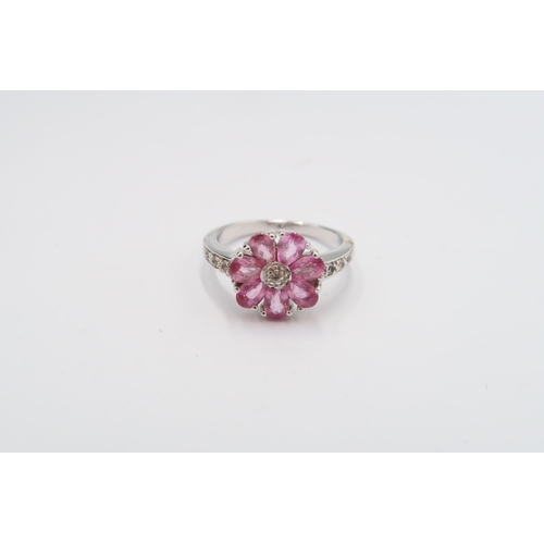 23 - A 9ct gold pink and white sapphire flower ring. Size N 1/2. Weight 3.96 grams